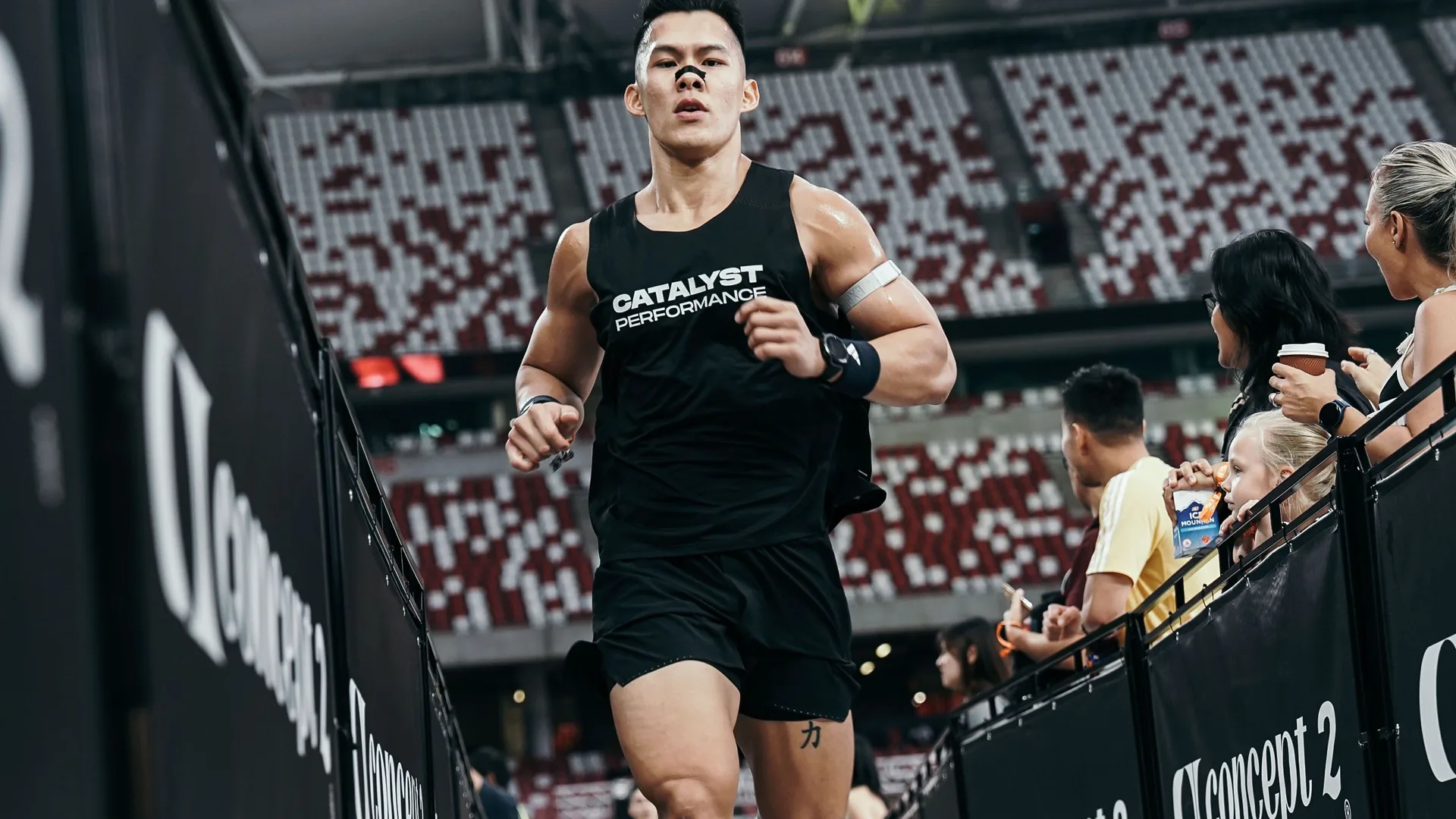 Jeremy running in CATALYST PERFORMANCE singlet at a HYROX race, Singapore Sports Hub