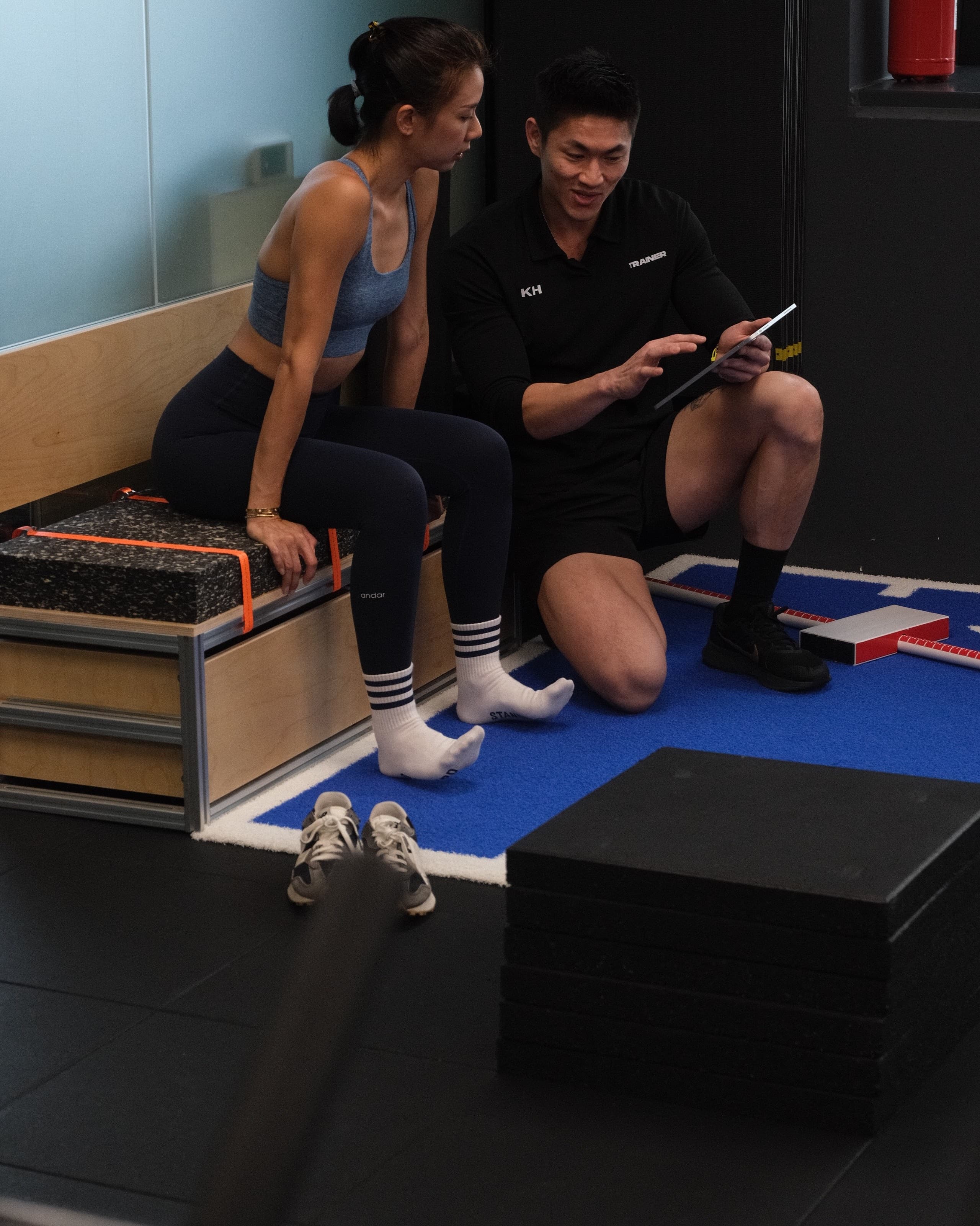 A Catalyst Performance coach guiding a client through resistance training in the Singapore CBD studio at Manulife Tower