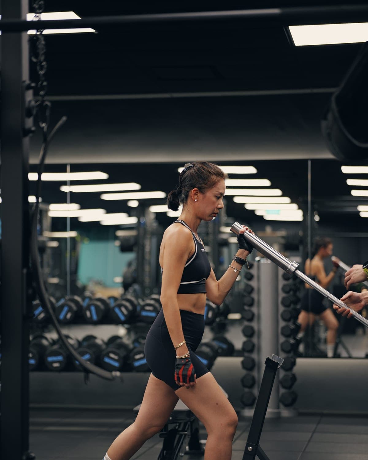 A Catalyst Performance member set up for a landmine press in the private Manulife Tower studio, 1:1 personal training in Singapore CBD