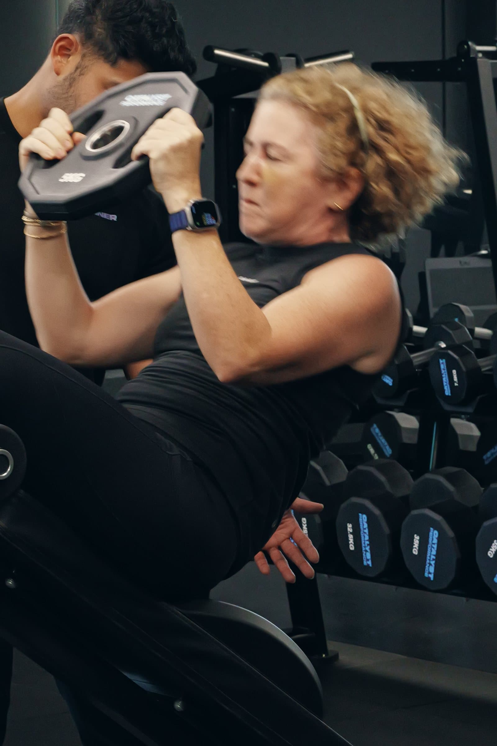 A mature female member training with a coach in the Catalyst Performance studio, Singapore CBD personal training