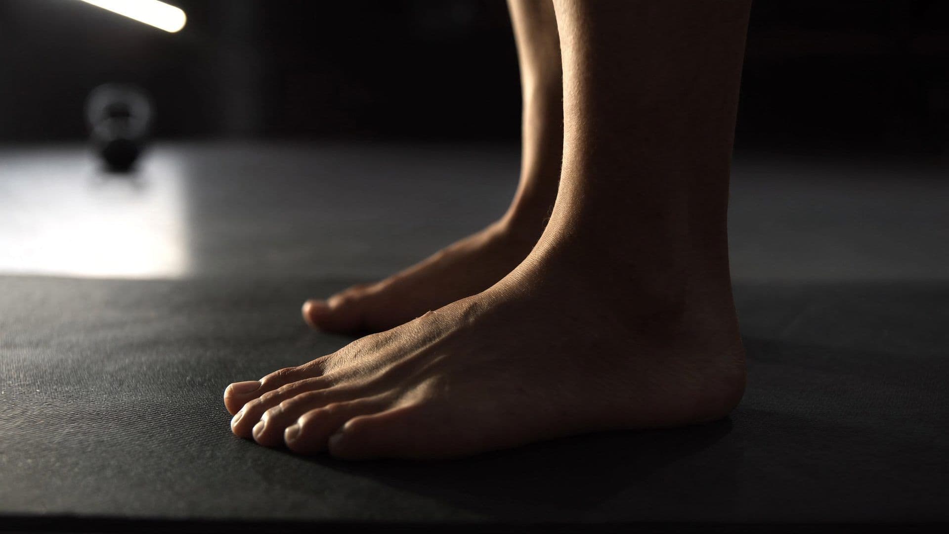 Side-profile torso shot of an athletic adult mid-activation on a yoga mat in a Singapore CBD personal training studio, deep-core brace position, neutral palette and natural light