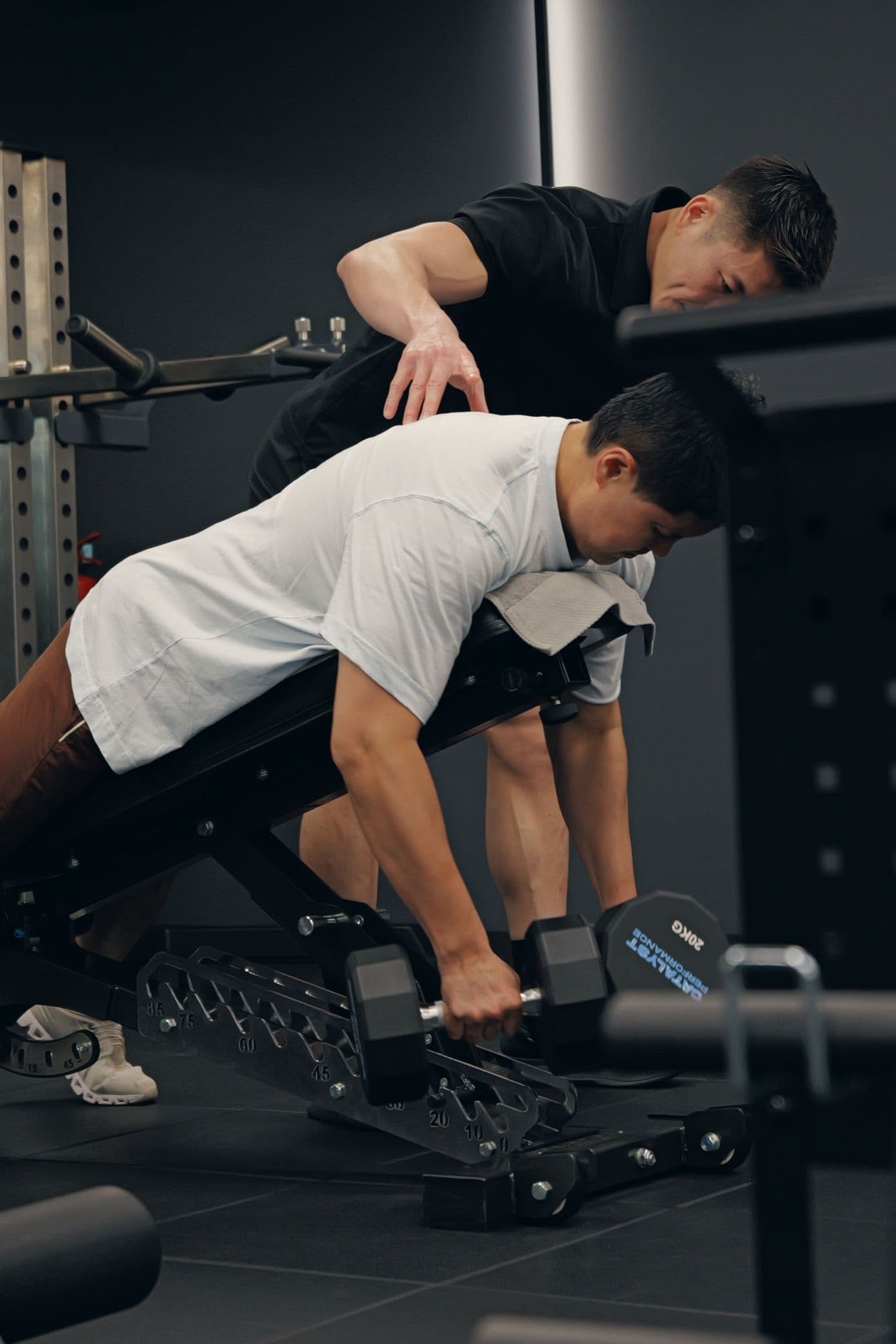 Coached dumbbell training on a quiet private gym floor in Singapore