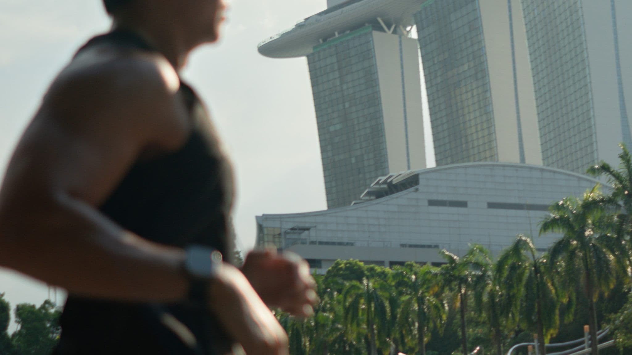A runner training along Marina Bay with the Marina Bay Sands in the background, Singapore