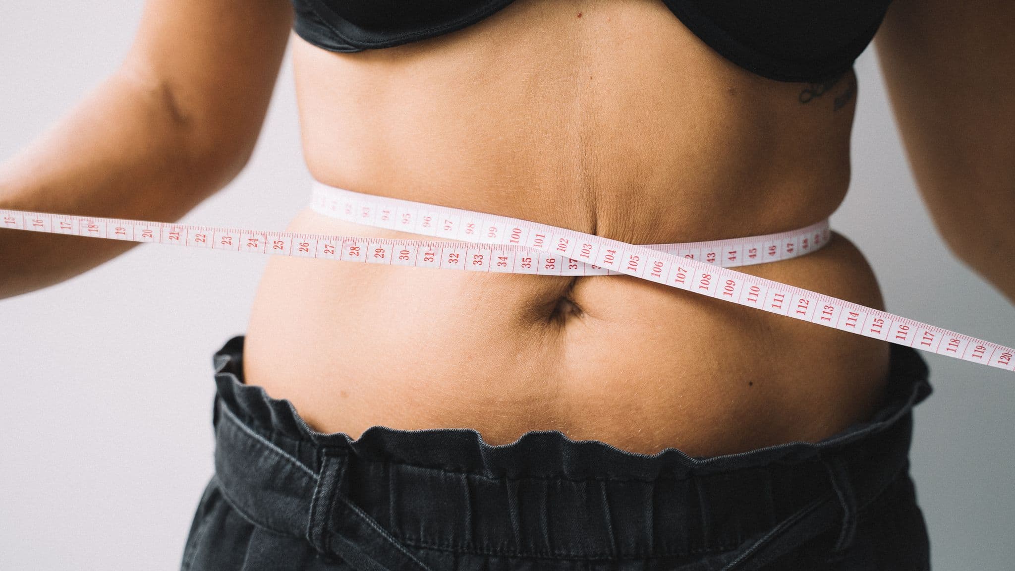 Measuring the waist with a tape measure