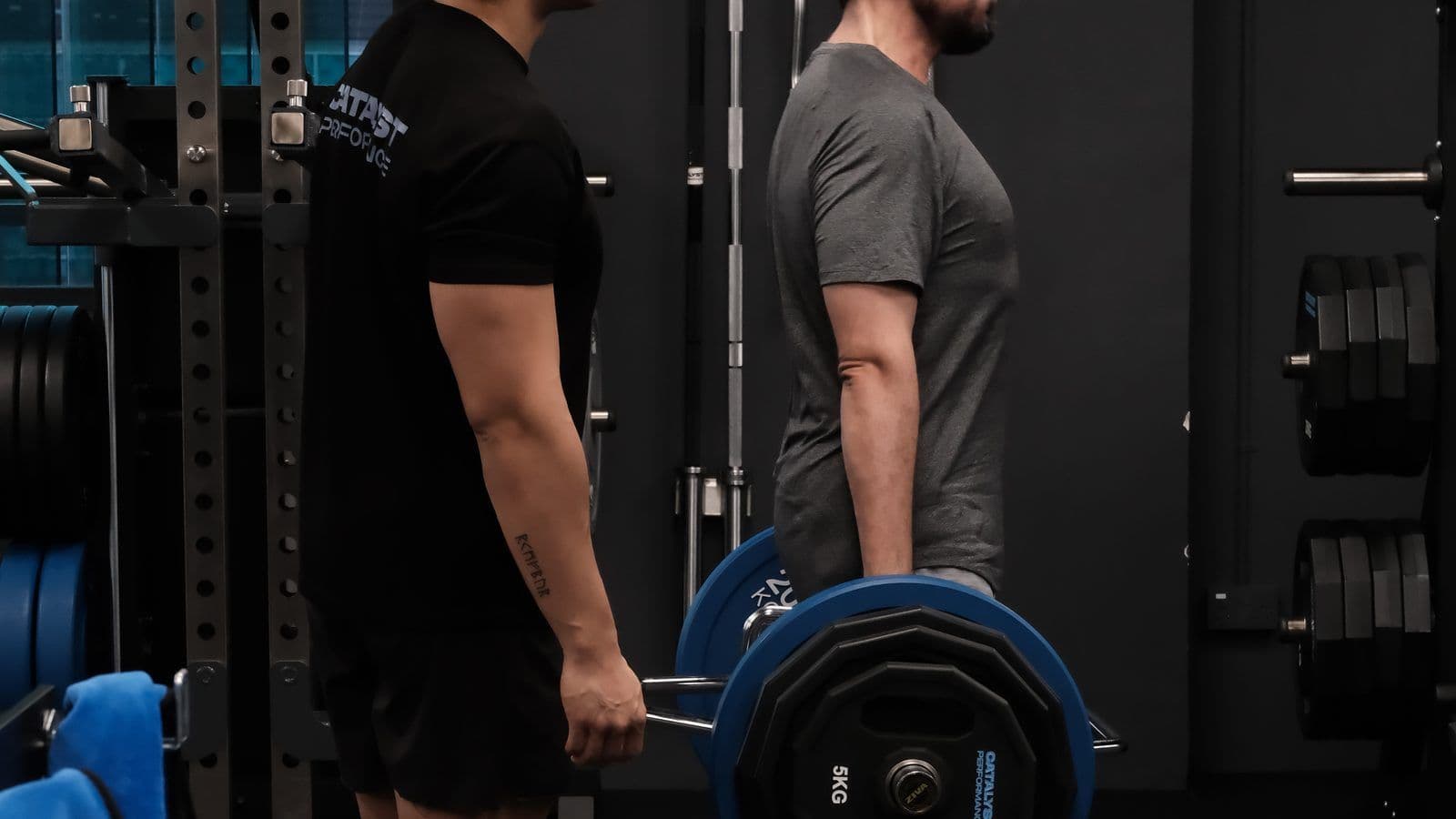 Client performing a trap-bar deadlift under coach supervision at Catalyst Performance, Singapore