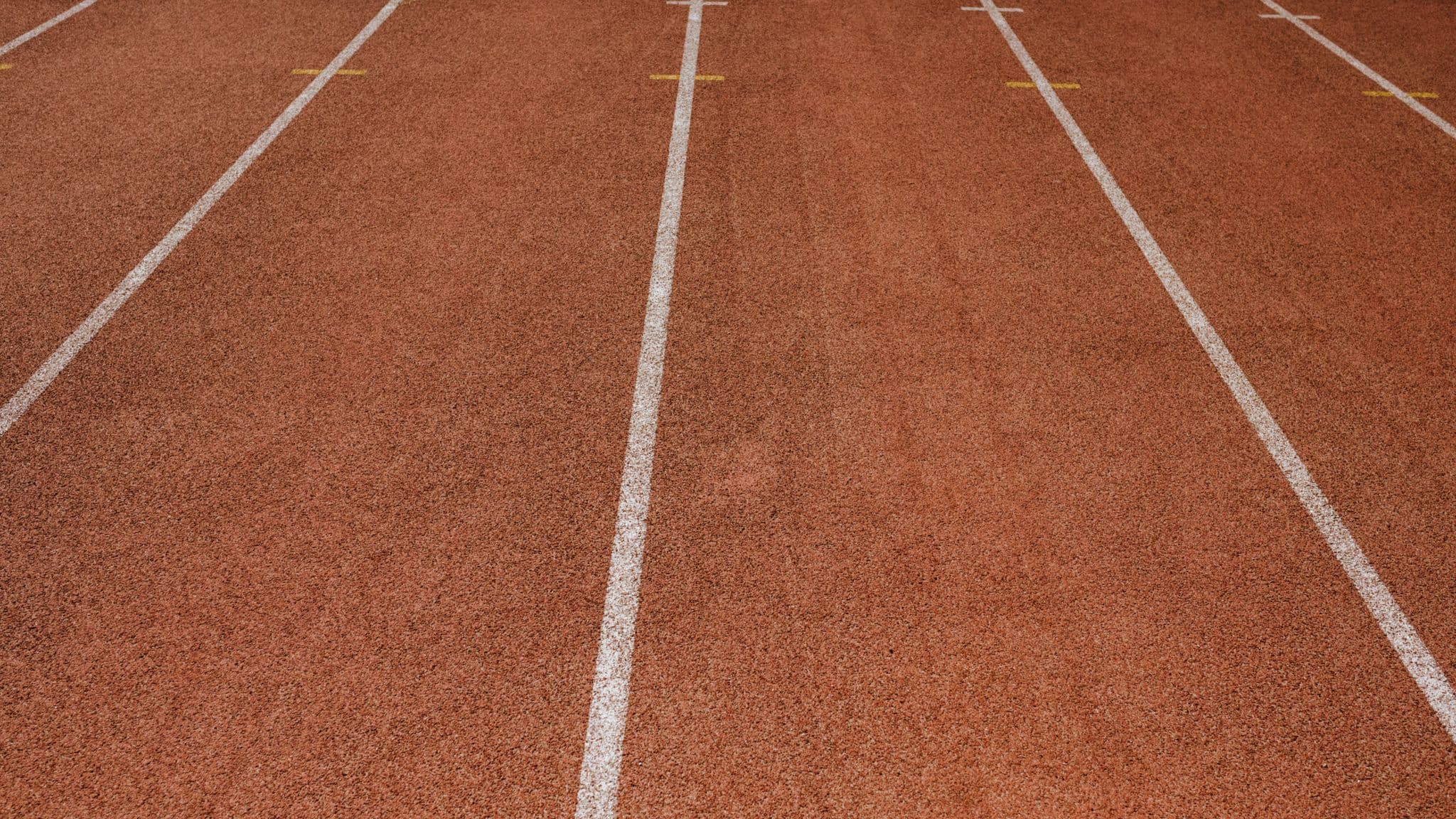 An empty running track with marked lanes