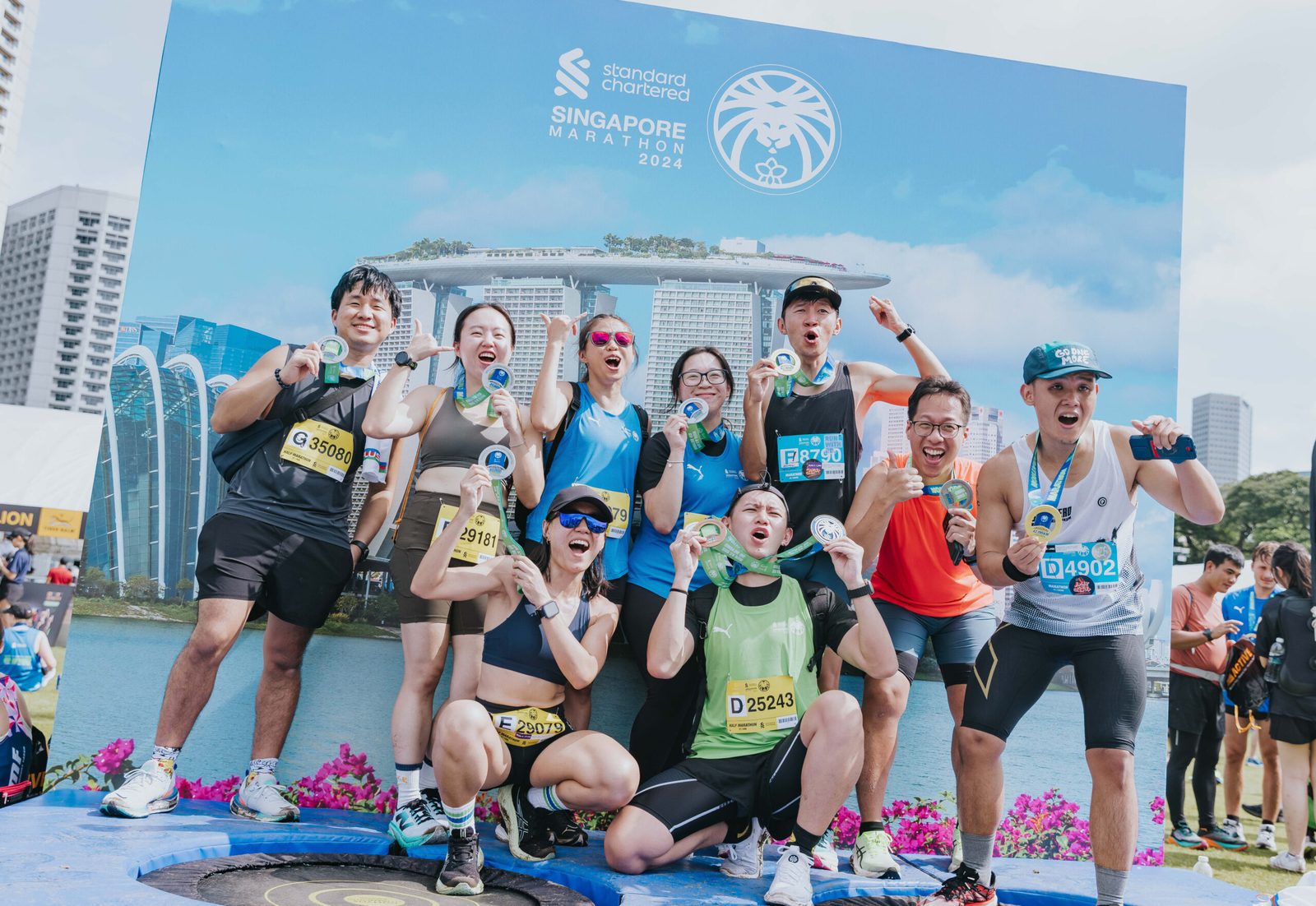 Finishers celebrating with their medals at the race village